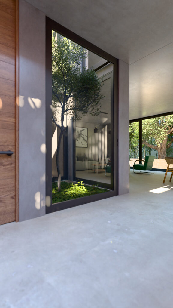 Patio interior acristalado con árbol central funcionando como núcleo de iluminación natural para la casa