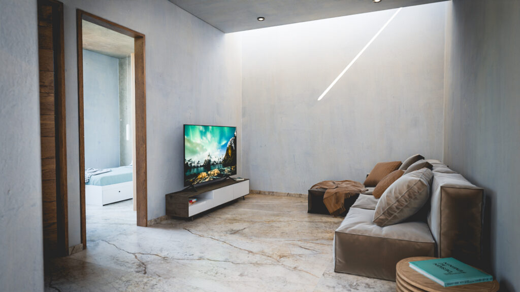 estar de televisión con muro de concreto aparente estilo industrial en Casa Roma
